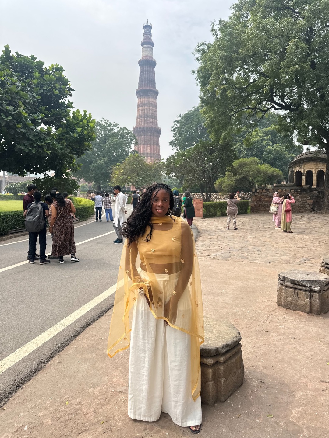 Rashana standing in front of Qutub Minar in New Delhi, India